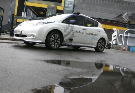 Nissan's head of automated driving, Tetsuya Lijima, sits at the controls of a modified Nissan Leaf, driverless car, during its first demonstration on public roads in Europe, in London, Britain February 27, 2017. REUTERS/Peter Nicholls