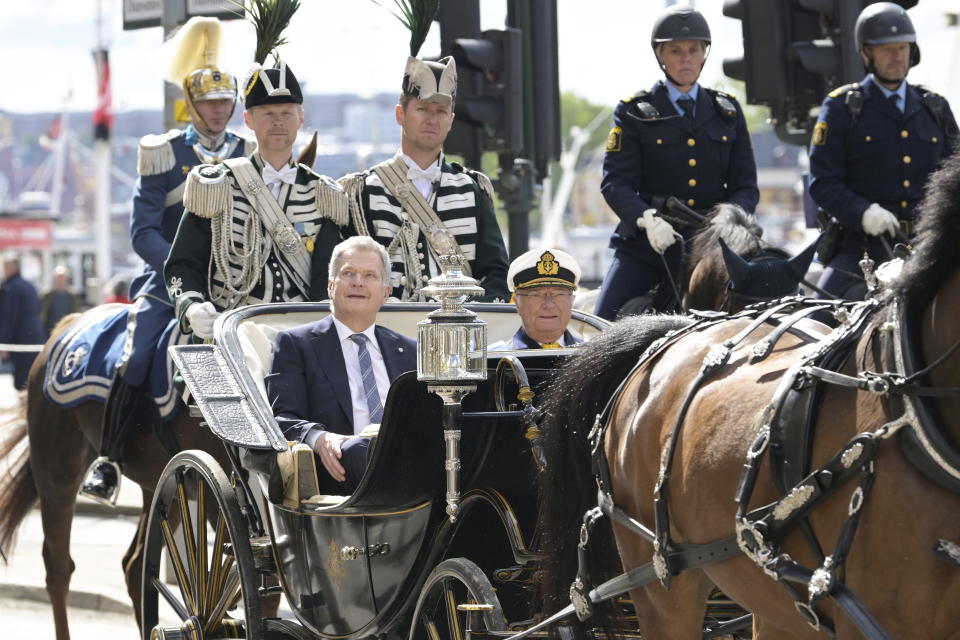 Finland's President Sauli Niinisto, left, sits next to Sweden's King Carl Gustaf as they ride in a horse carriage in central Stockholm, Tuesday, May 17, 2022. Finland's President Niiniste and his wife Jenni Haukio are on a two-day long state visit to Sweden (Anders Wiklund/TT News Agency via AP)