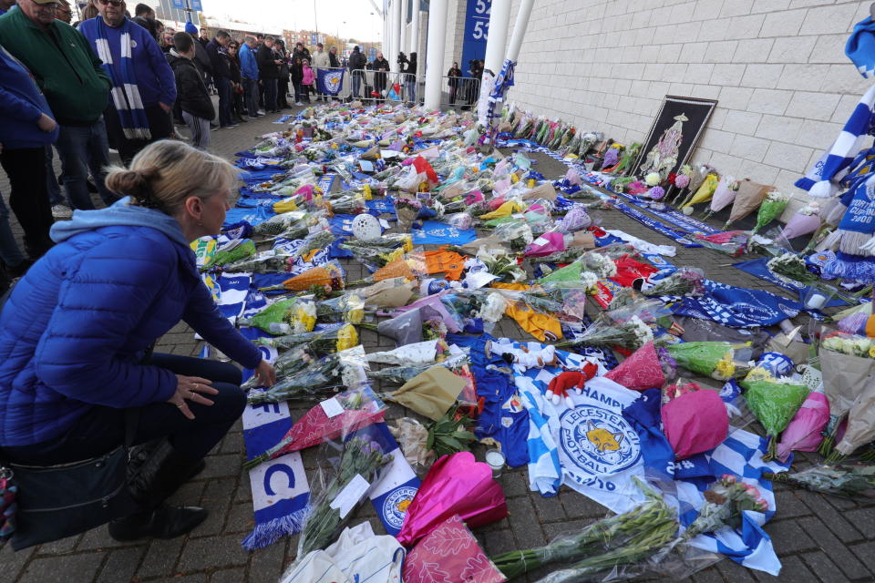 Supporters pay tribute to Leicester City club owner Vichai Srivaddhanaprabha, who died when his helicopter crashed in a car park near the club’s stadium on 27 October, 2018. (PHOTO: Aaron Chown/PA via AP)