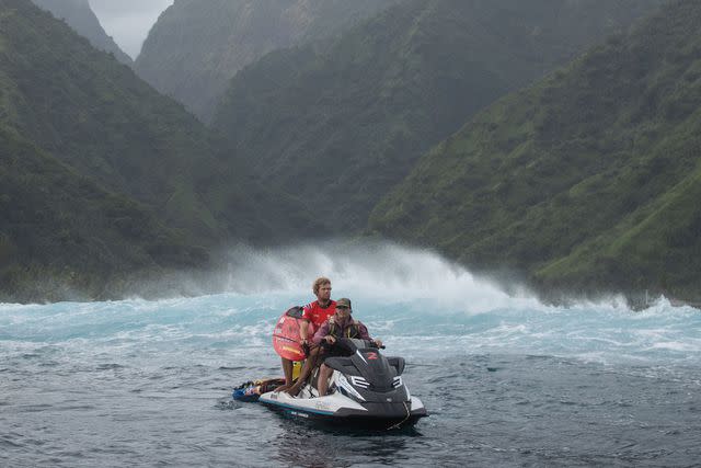 <p>Ryan Pierse/Getty</p> John John Florence arrives on a jetski to surf his heat at the 2023 Tahiti Pro