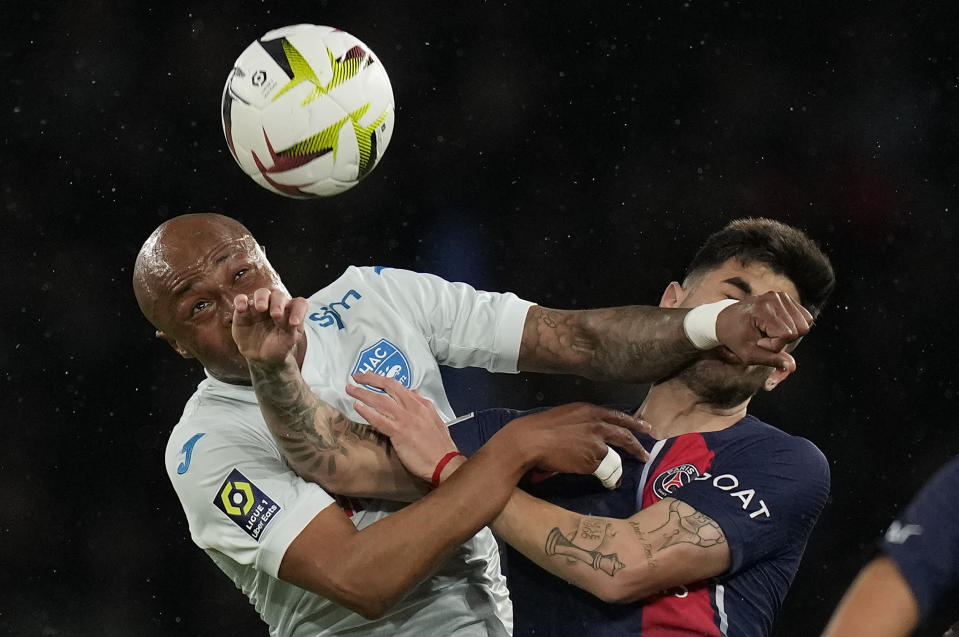 Le Havre's Andre Ayew, left, and PSG's Ethan Mbappe battle for the ball during the French League One soccer match between Paris Saint-Germain and Le Havre at the Parc des Princes in Paris, Saturday, April 27, 2024. (AP Photo/Thibault Camus)