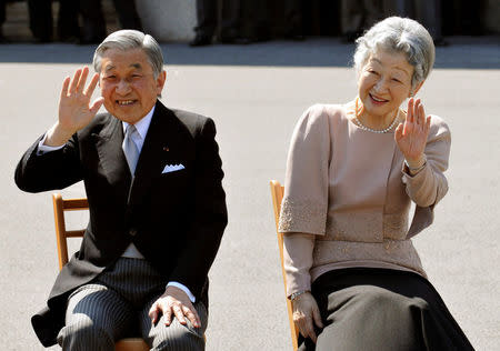 FILE PHOTO: Japan's Emperor Akihito (L) and Empress Michiko wave to well-wishers as they listen to the Imperial Guard music band's performance in celebration of their 50th wedding anniversary in the Imperial Palace compound in Tokyo April 10, 2009. REUTERS/Katsumi Kasahara/Pool/File Photo