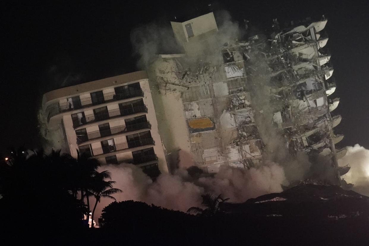 The damaged remaining structure at the Champlain Towers South condo building collapses in a controlled demolition, Sunday, July 4, 2021, in Surfside, Fla. The decision to demolish the Surfside building came after concerns mounted that the damaged structure was at risk of falling, endangering the crews below and preventing them from operating in some areas.