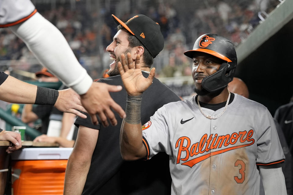 Baltimore Orioles' Jorge Mateo (3) is congratulated by his teammates after scoring against the Washington National in the 12th inning of a baseball game at Nationals Park in Washington, Wednesday, May 8, 2024. (AP Photo/Susan Walsh)