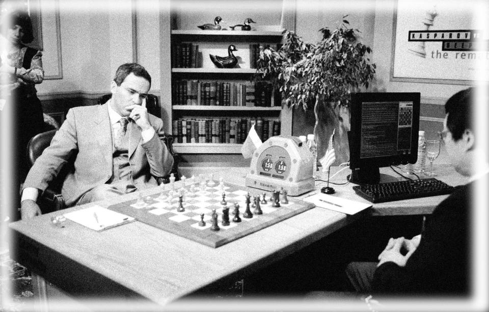 Chess Grand Master Gary Kasparov, left, comtemplates his next move against IBM's Deep Blue chess computer while Chung-Jen Tan, manager of the Deep Blue project looks on in New York, Saturday, May 3, 1997, during the first game of a six-game rematch between Kasparov and Deep Blue. The computer program made history last year by becoming  the first to beat a world chess champion, Kasparov, at a serious  game. (Photo: Adam Nadel/AP, digitally enhanced by Yahoo News)