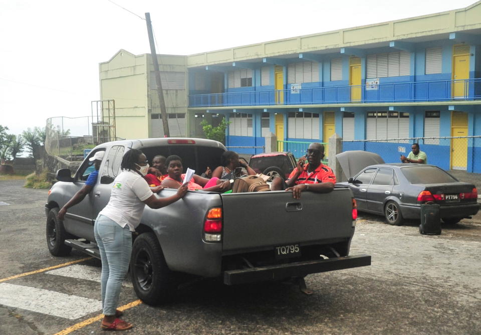 A NEMO (National Emergency Management Organisation of St Vincent and the Grenadines) official ensures all evacuees are safe before giving approval to the driver to depart following the eruption of La Soufriere volcano on the eastern Caribbean island of St Vincent.