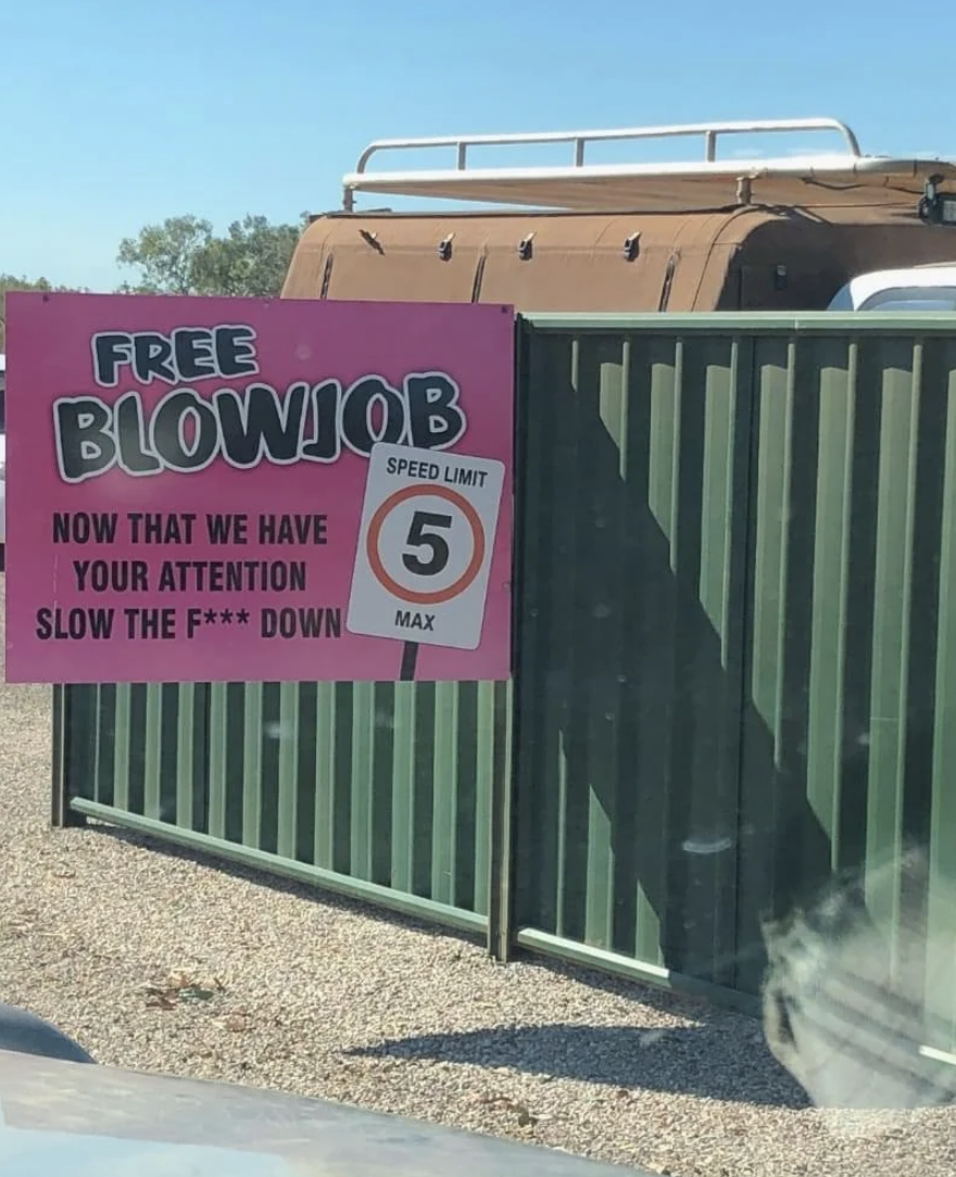 Sign humorously advertises a "FREE BLOWJOB" to capture attention for a 5 mph speed limit reminder