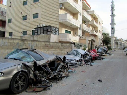 A handout picture taken in February 2012, and released by the official Committee of the Syrian Revolution, allegedly shows damaged cars demolished by Syrian forces driving over them with army tanks in the flashpoint city of Homs. UN-Arab League envoy Kofi Annan left Damascus on Sunday without managing to secure an accord to end bloodletting in Syria
