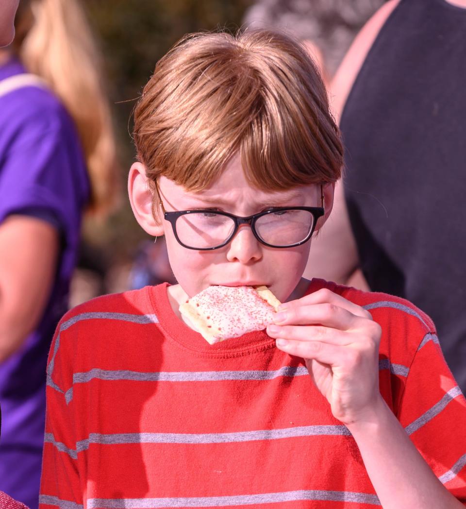 A young boy enjoys pop tarts during 2019 National Cereal Festival in downtown Battle Creek on Saturday, June 8, 2019.