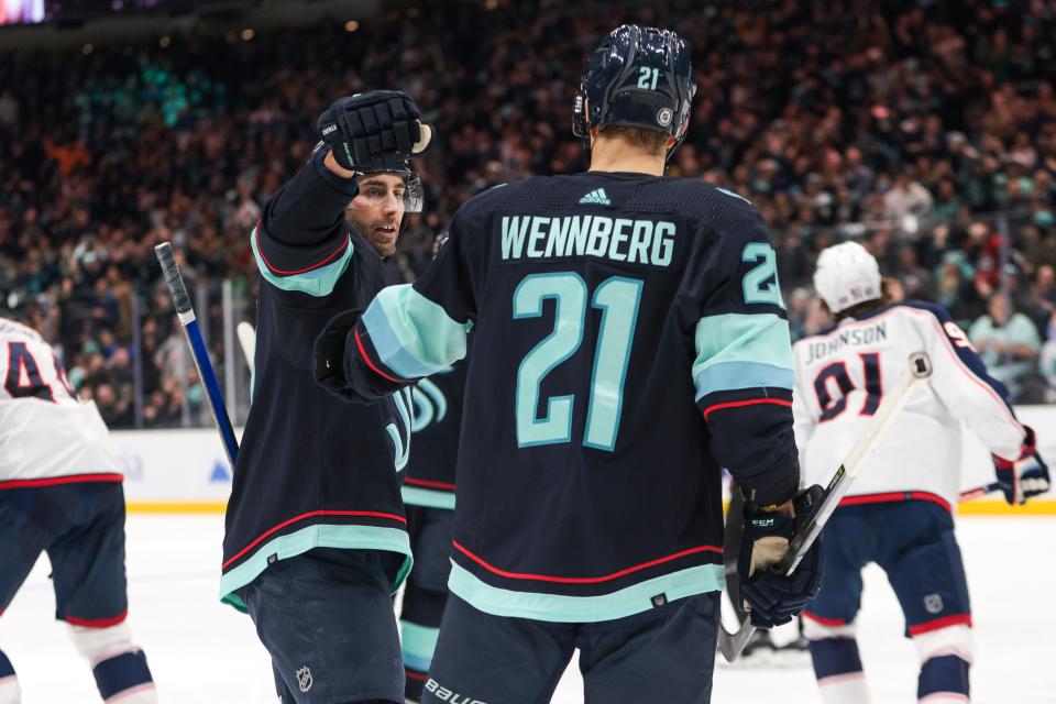 Seattle Kraken right wing Jordan Eberle, left, congratulates center Alex Wennberg on a goal during the second period of the team's NHL hockey game against the Columbus Blue Jackets on Saturday, Jan. 28, 2023, in Seattle. (AP Photo/Jason Redmond)