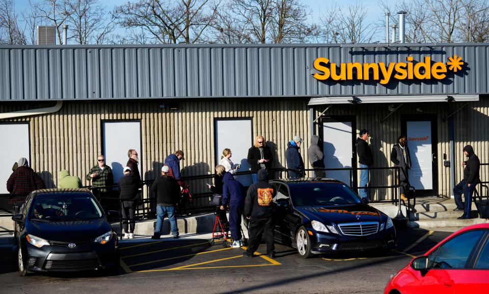 People wait for the doors to open Thursday at Sunnyside Medical Marijuana Dispensary in Madisonville. Though Issue 2 passed and the use of recreational marijuana went into effect Thursday, you cannot buy recreational marijuana yet.