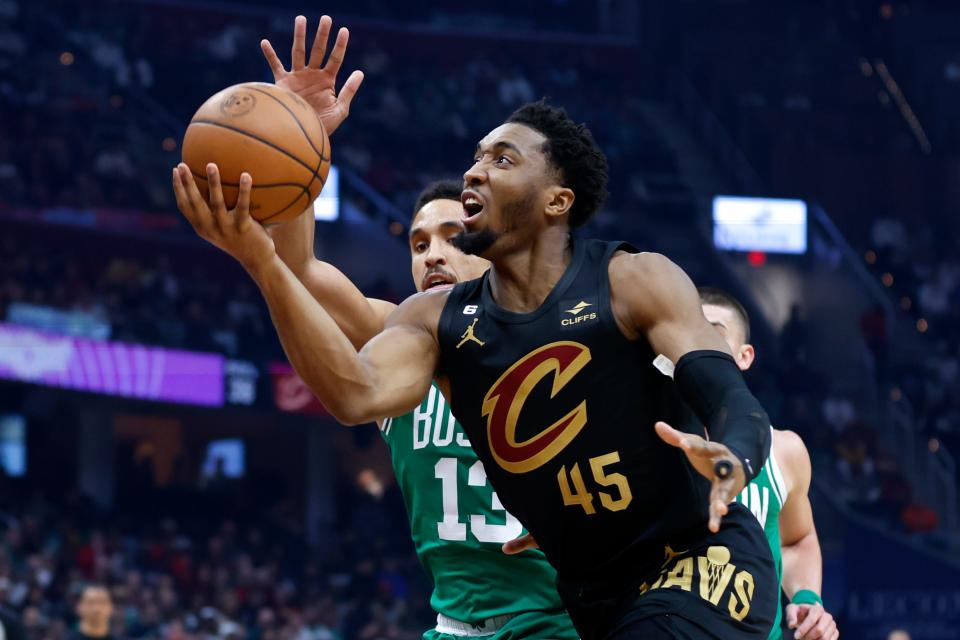 Cleveland Cavaliers guard Donovan Mitchell (45) shoots against Boston Celtics guard Malcolm Brogdon during the first half of an NBA basketball game, Monday, March 6, 2023, in Cleveland. (AP Photo/Ron Schwane)