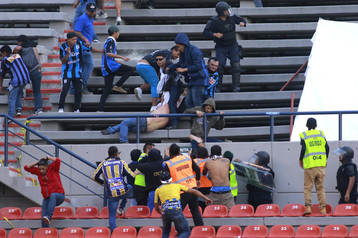 SAN LUIS POTOSI, MEXICO - OCTOBER 20:  Fans of San Luis and Queretaro fight in the stands during the 14th round match between Atletico San Luis and Queretaro as part of the Torneo Apertura 2019 Liga MX at Estadio Alfonso Lastras on October 20, 2019 in San Luis Potosi, Mexico. (Photo by Cesar Gomez/Jam Media/Getty Images)
