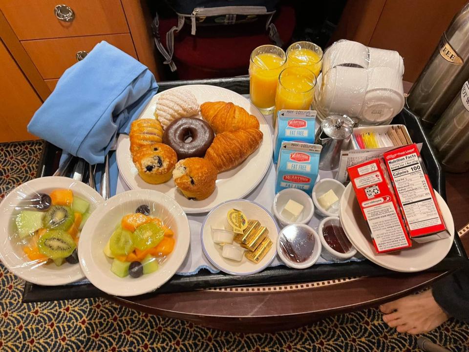 breakfast tray on a coffee table in a deluxe inside stateroom on a disney magic cruise