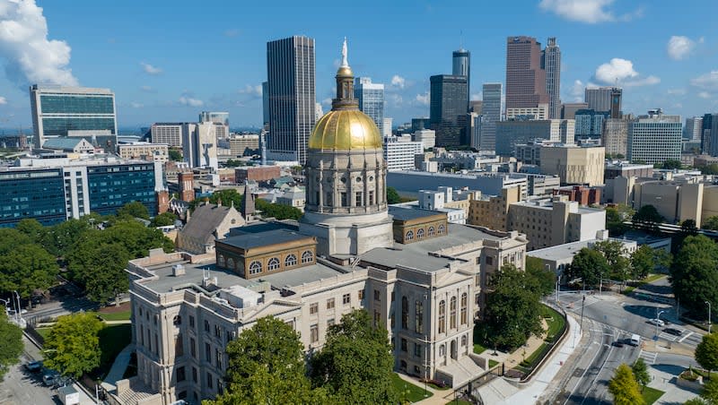 The gold dome of the Georgia Capitol gleams in the sun, Aug. 27, 2022, in front of the skyline of downtown Atlanta. Atlanta joined Salt Lake City this week in a public quest to land an NHL club.