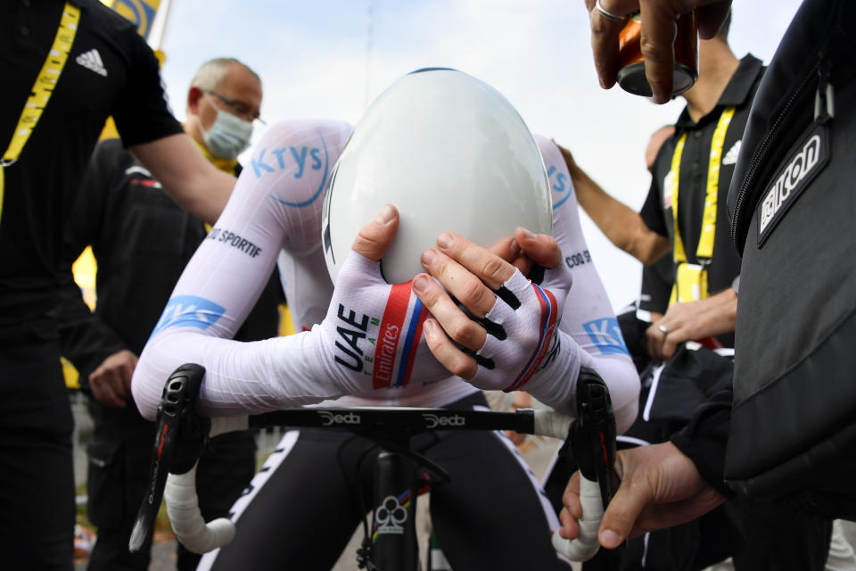 New overall leader, best young rider and best climber, Slovenia's Tadej Pogacar, grabs his head after crossing the finish line to win stage 20 of the Tour de France cycling race, an individual time trial over 36.2 kilometers (22.5 miles), from Lure to La Planche des Belles Filles, France, Saturday, Sept. 19, 2020. (Bernard Papon/Pool via AP)