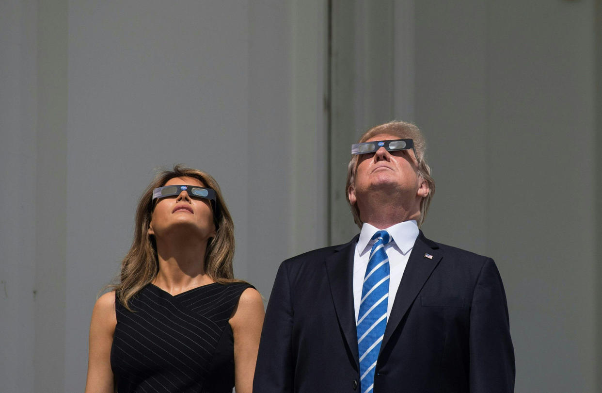 Image: Trump and and Melania look up at the solar eclipse from the balcony of the White House (Nicholas Kamm / AFP - Getty Images file)