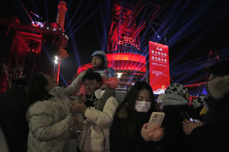 Revellers take photos after a count down to the new year at the Shougang Park in Beijing, Sunday, Jan. 1, 2023. (AP Photo/Ng Han Guan)