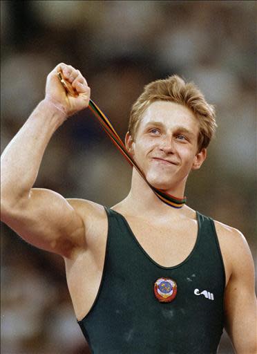 All around individual gymnast gold medalist Vitaly Scherbo from Unified team (Belarus), shows his gold medal to the public, Barcelona, 31 July 1992. Scherbo won 6 gold medals in Barcelona. Later, during the 1996's Olympic games, he took 3 bronze medals