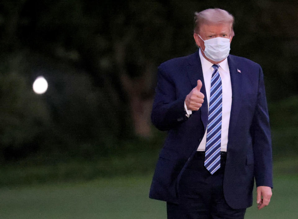 U.S. President Donald Trump gestures upon return to the White House from Walter Reed National Military Medical Center. Source: Getty