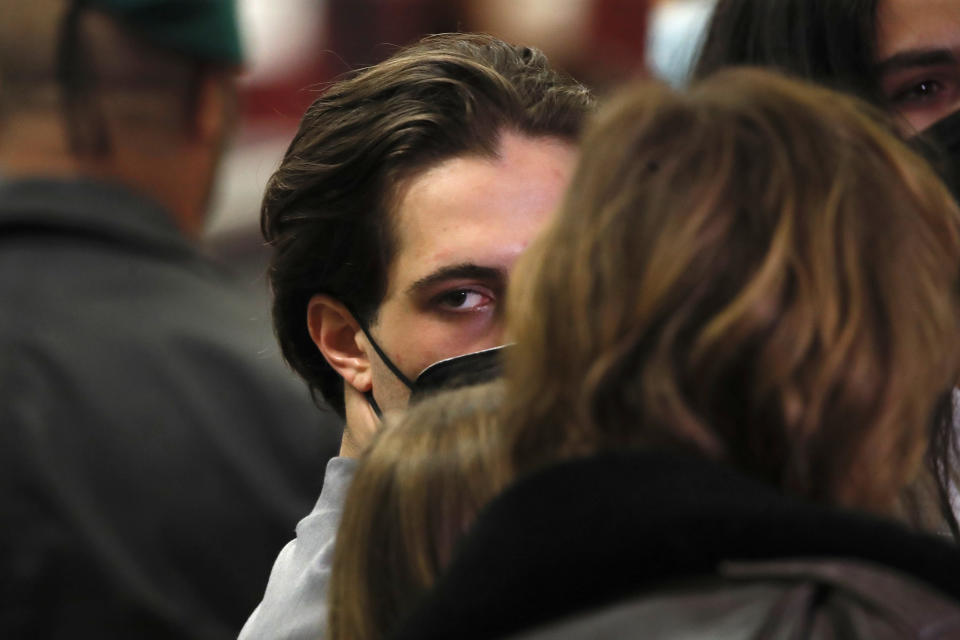 Damiano David of Italian band Maneskin, turns as he listens to reporters' questions upon their arrival at Rome's Fiumicino airport, Sunday, May 23, 2021. The glam rock band who got their start busking on Rome's main shopping drag won the Eurovision Song Contest Saturday and brought next year's competition back to the place where Europe's song contests began. (AP Photo/Alessandra Tarantino)