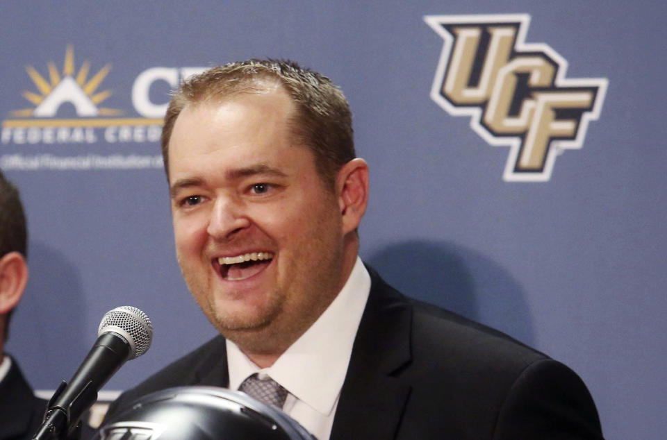 FILE - In this Dec. 5, 2017, file photo, Josh Heupel smiles as he is introduced as the new Central Florida head football coach during an NCAA college football news conference in Orlando, Fla. Heupel, who was the Heisman Trophy runner-up for Oklahoma in 2000, and former North Carolina pass-rushing star Julius Peppers are among 12 players making their first appearance of the College Football Hall of Fame ballot this year. (Red Huber/Orlando Sentinel via AP, File)/Orlando Sentinel via AP)