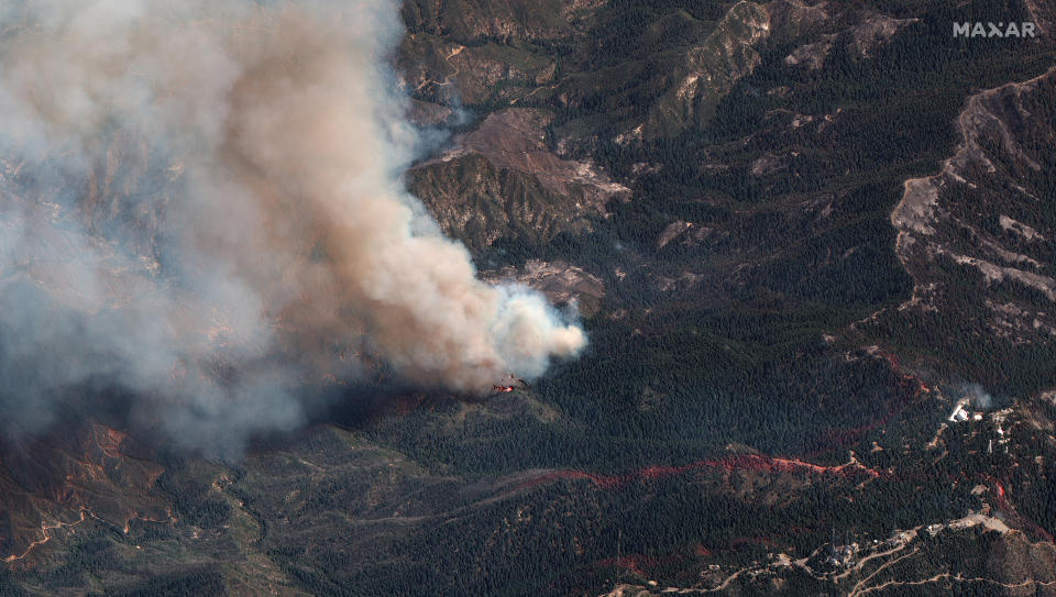 This natural color photo provided by Maxar Technologies shows the fire lines of an area of the Bobcat Fire, Monday, Sept. 21, 2020, burning northeast of Los Angeles. The Mount Wilson Observatory can be seen, far right. (Satellite image ©2020 Maxar Technologies via AP)