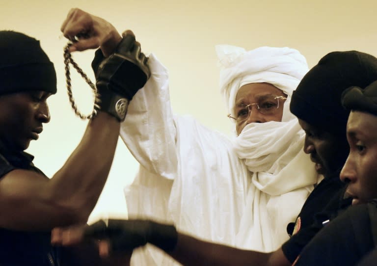 Former Chadian dictator Hissene Habre (C), pictured being escorted into court, is making history in the dock of a special tribunal in Senegal over his regime's brutality