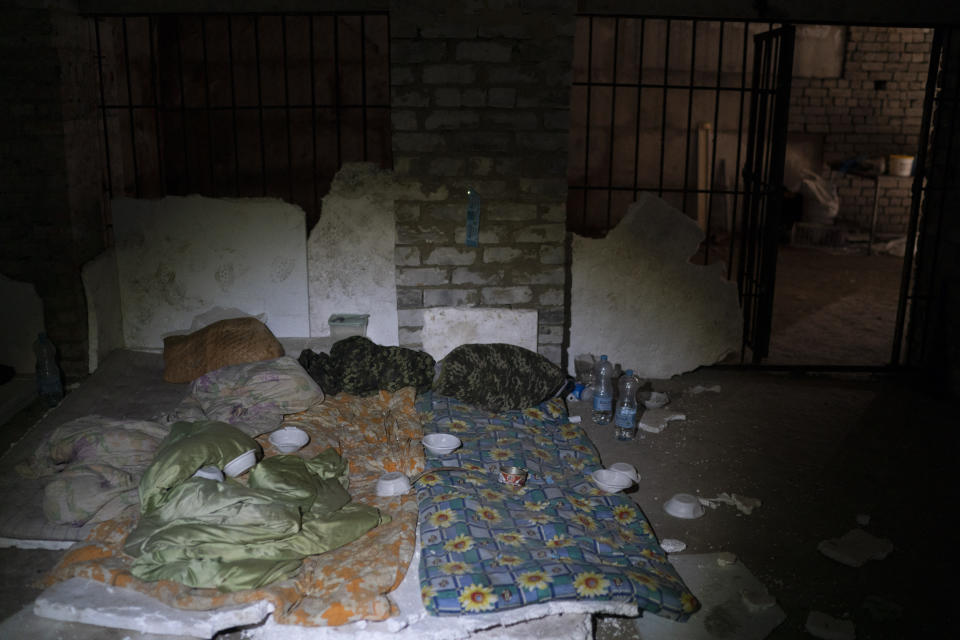 Duvets and sleeping bag are seen in a basement which, according to Ukrainian authorities, was used as a torture cell during the Russian occupation, in the retaken village of Kozacha Lopan, Ukraine, Saturday, Sept. 17, 2022. (AP Photo/Leo Correa)