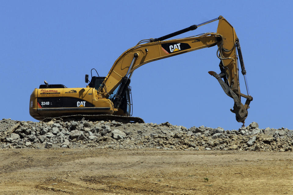 FILE - In this Wednesday, June 20, 2012, file photo a caterpillar machine is used at the Clinton Landfill in Clinton, Ill. Caterpillar cut its profit and revenue guidance on Monday, Oct. 22, 2012, saying the world’s economic conditions “are weaker than we had previously expected.” Caterpillar Inc. is the world’s largest construction and mining equipment maker, so its results are watched closely as a sign of where the broader economy is headed. (AP Photo/Seth Perlman, File)