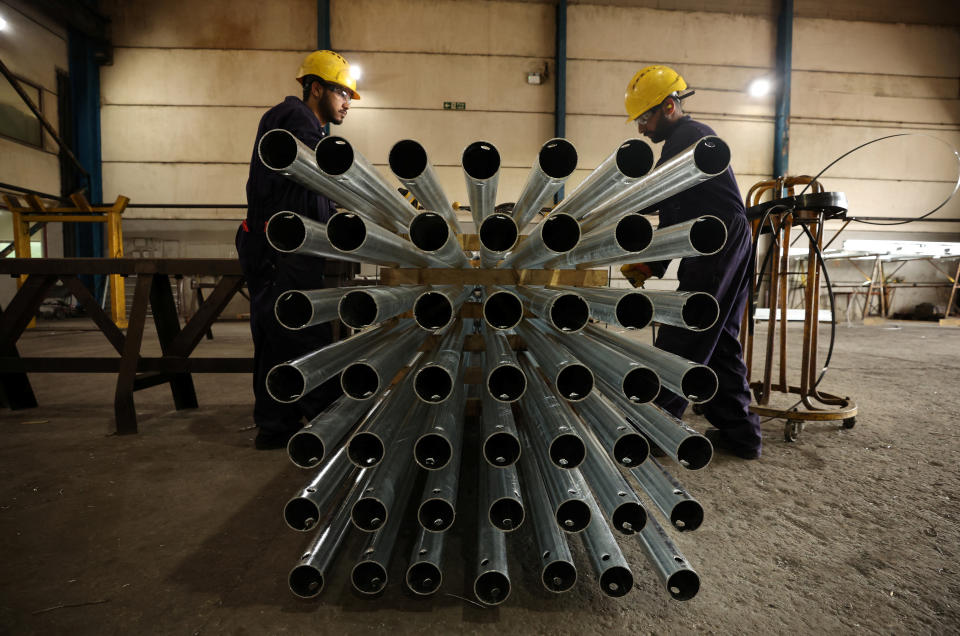 UK businesses Workers adjust a consignment of freshly galvanised street lamps inside the factory of Corbetts The Galvanizers in Telford, Britain, June 28, 2022. REUTERS/Phil Noble