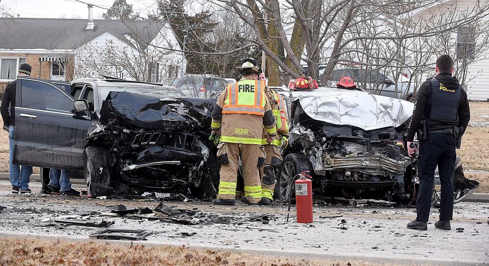 Columbia firefighters and police look at the scene of a two-vehicle head-on collision in the 3300 block of Brown Station Road Friday afternoon.