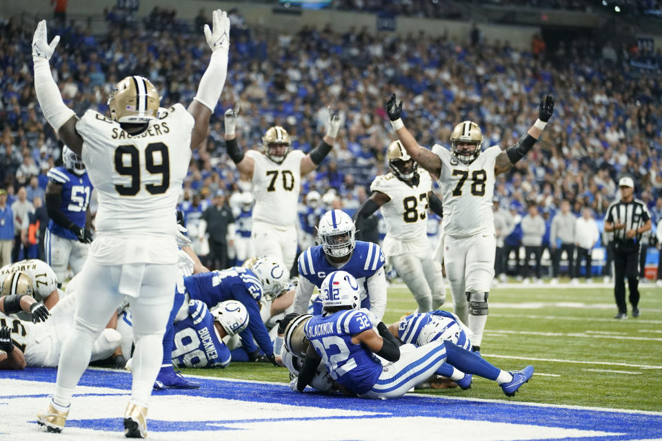New Orleans Saints players celebrate a Taysom Hill one-yard touchdown run against the Indianapolis Colts during the second half of an NFL football game Sunday, Oct. 29, 2023 in Indianapolis. (AP Photo/Michael Conroy)