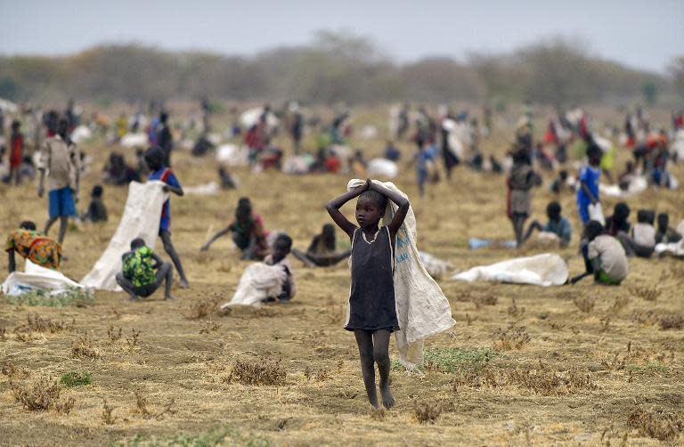Children flock with containers to a field demarcated for food-drops at a village in Nyal, Unity state, south Sudan, on February 24, 2015