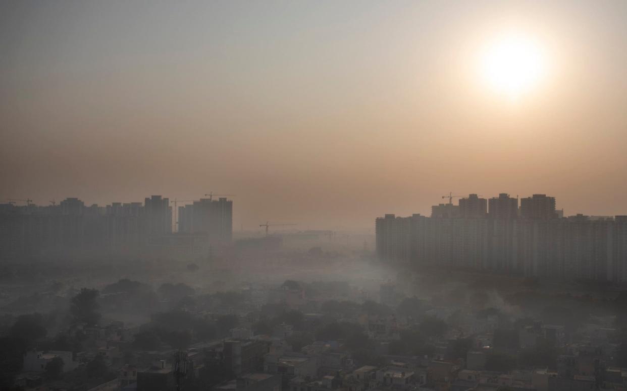 Morning haze envelops the skyline on the outskirts of New Delhi, which is one of the most polluted cities in the world - Altaf Qadri /AP