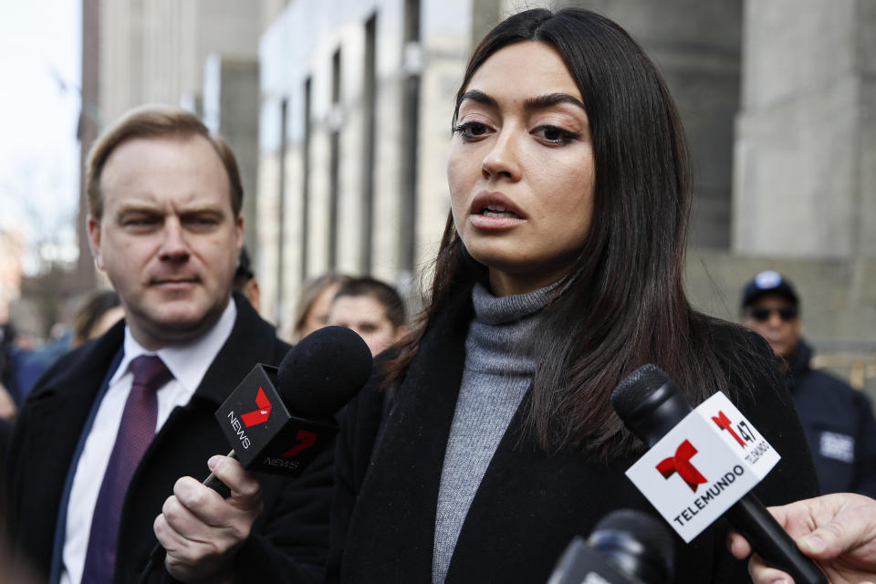 Ambra Battilana Gutierrez speaks to reporters outside of a Manhattan courthouse after Harvey Weinstein was convicted in his rape trial, Monday, Feb. 24, 2020, in New York. A jury convicted Weinstein of rape and sexual assault. The jury found him not guilty of the most serious charge, predatory sexual assault, which could have resulted in a life sentence. (AP Photo/John Minchillo)