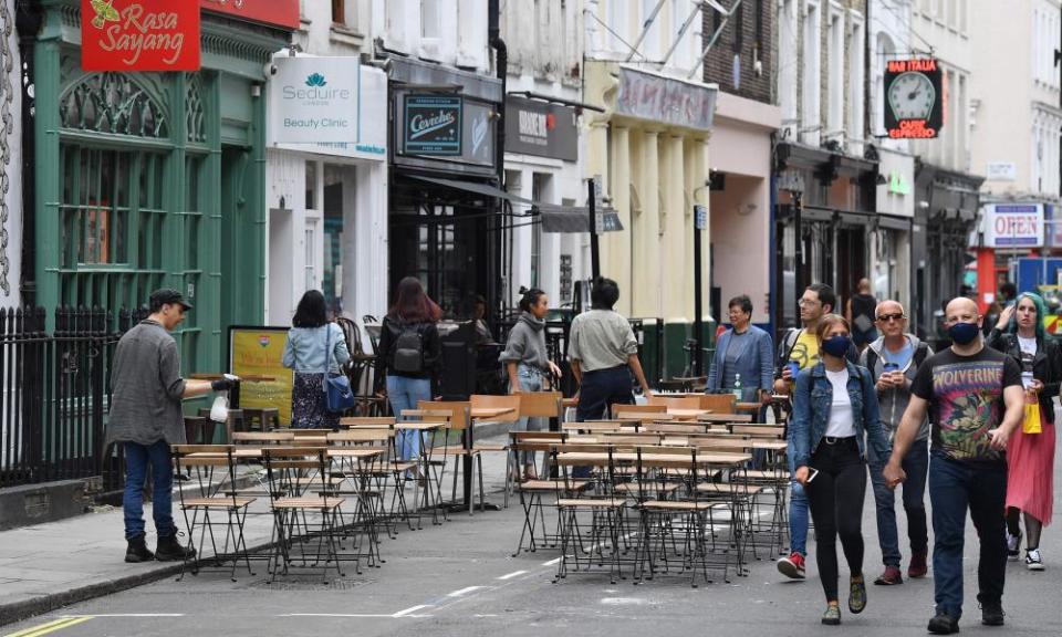 Tables have been put out for customers outside a restaurant in Soho.