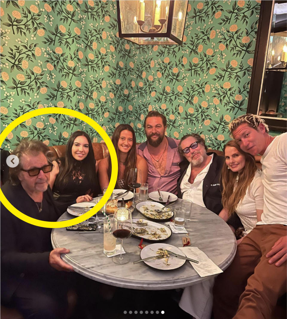 Pacino sitting next to his partner and others, including Jason Momoa, at a restaurant