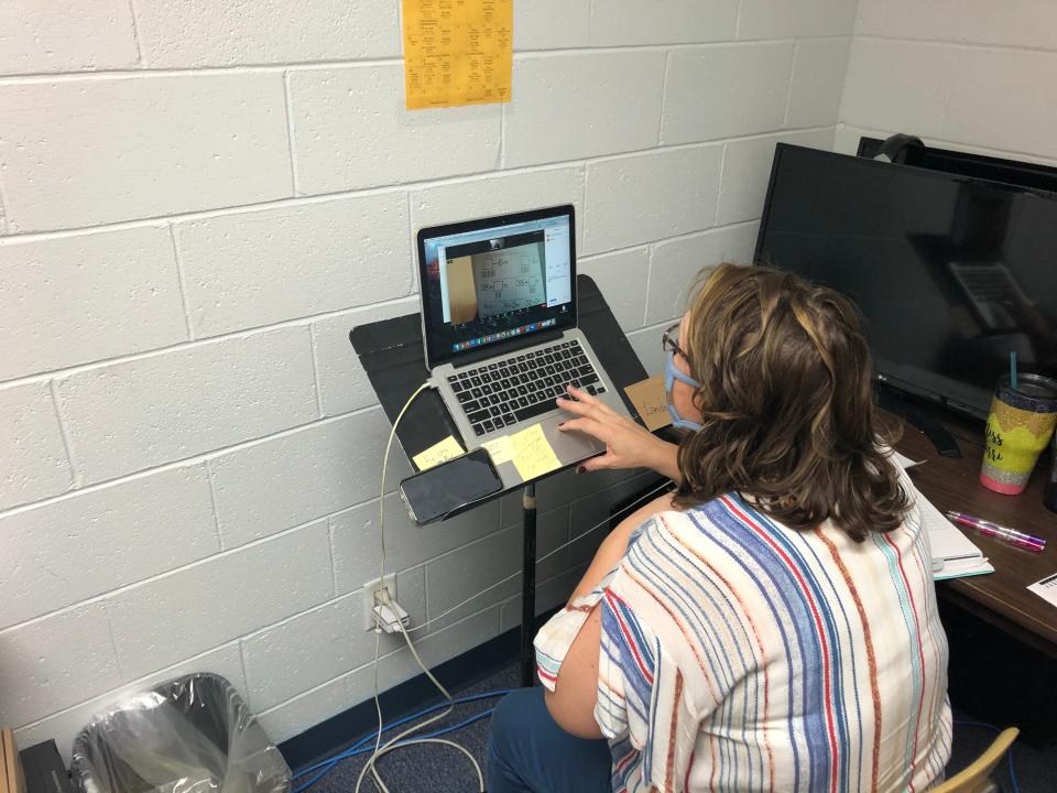 A remote learning teacher at Bancroft-Rosalie Schools checks an elementary student's work on Zoom.