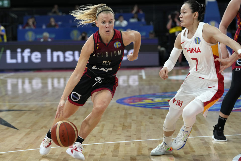 Belgium's Julie Vanloo, left, goes around China's Yang Liwei during their game at the women's Basketball World Cup in Sydney, Australia, Tuesday, Sept. 27, 2022. (AP Photo/Rick Rycroft)