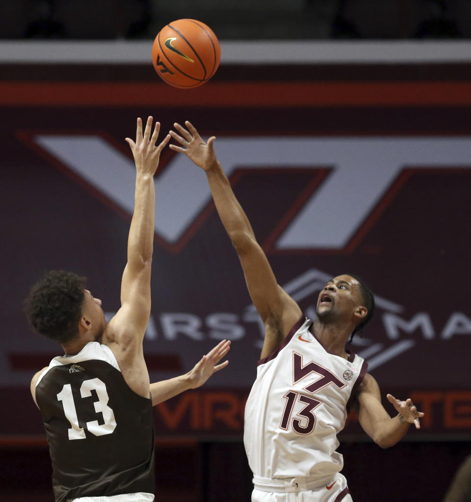 Lehigh's Keith Higgins Jr., left, shoots over Virginia Tech's Darius Maddox (13) during the first half of an NCAA college basketball game Thursday, Nov. 10, 2022, in Blacksburg, Va. (Matt Gentry/The Roanoke Times via AP)