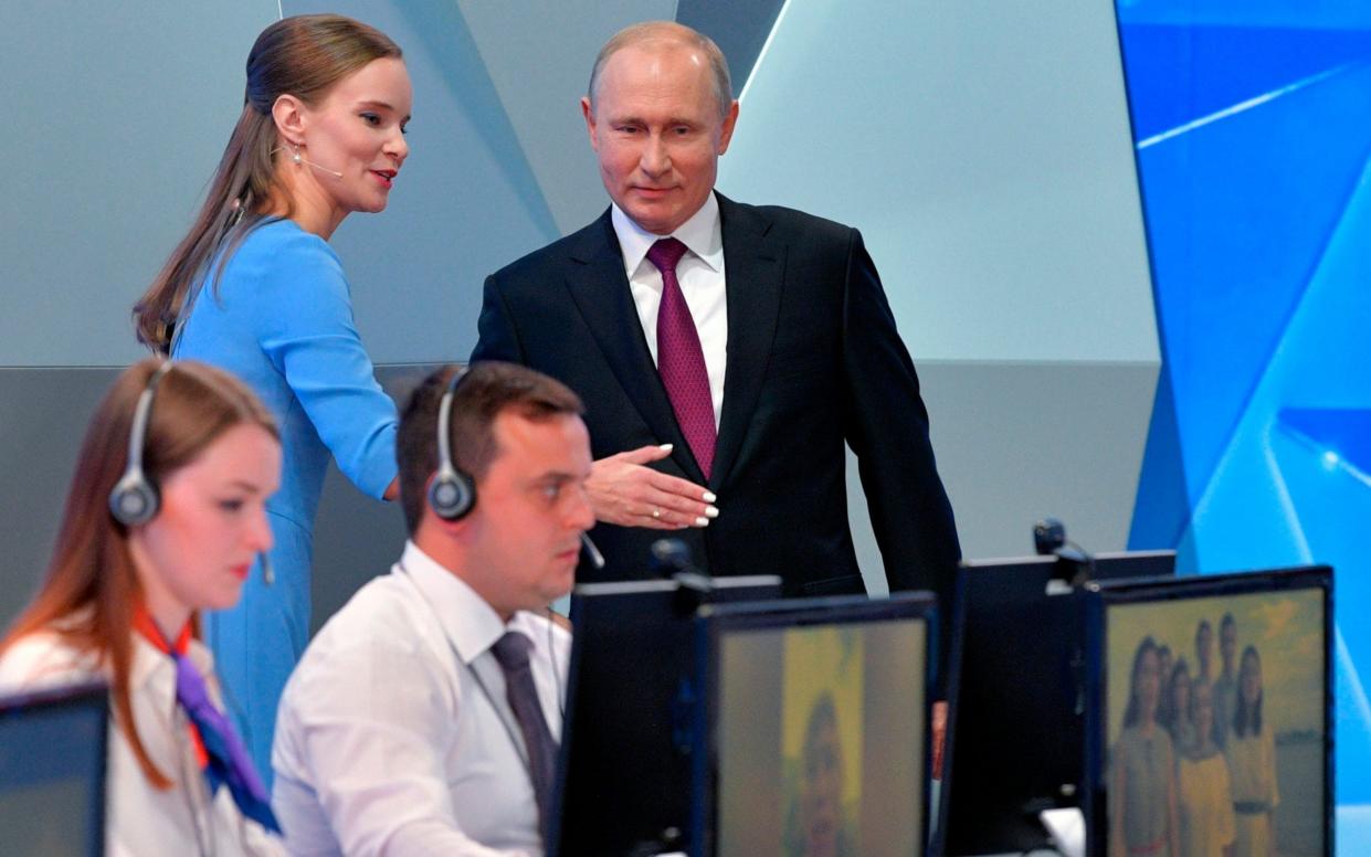 Vladimir Putin enters the state television studio for his annual call-in show on Thursday - Pool Sputnik Kremlin