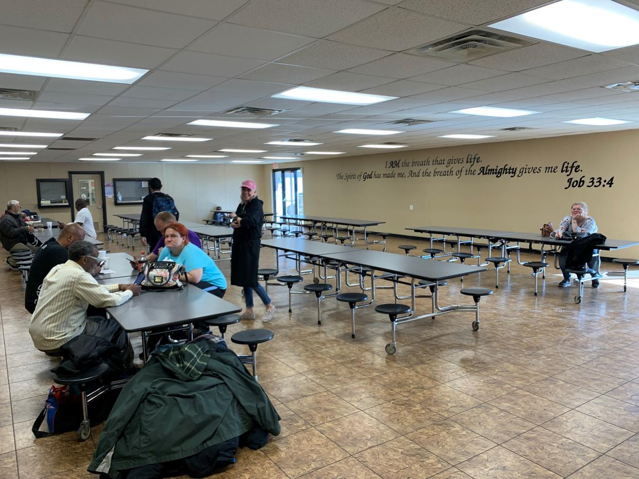 Clients gather in the cafeteria to wait for lunch to be served at Love and Care Ministries on March 13, 2024.