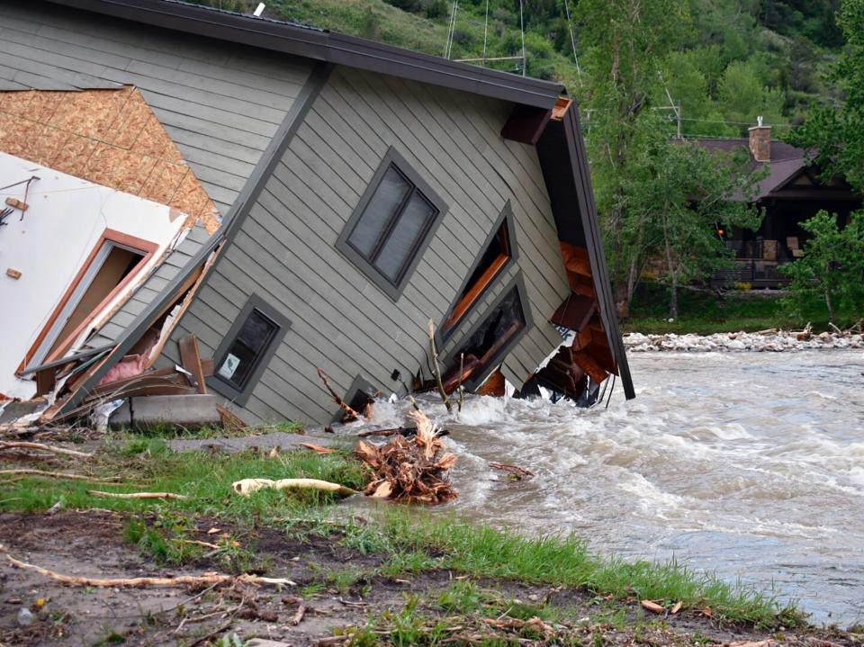 A home pulled into the water in Red Lodge, Montana (AP)