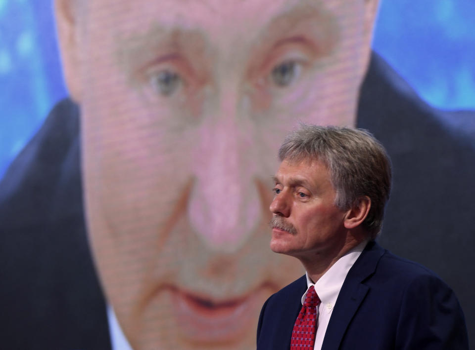 Kremlin spokesman Dmitry Peskov sits in front of a screen displaying Russian President Vladimir Putin addressing his annual press conference via a video link from the Novo-Ogaryovo state residence, at the World Trade Centre's congress centre in Moscow on December 17, 2020, amid the ongoing coronavirus disease pandemic. (Photo by NATALIA KOLESNIKOVA / AFP) (Photo by NATALIA KOLESNIKOVA/AFP via Getty Images)