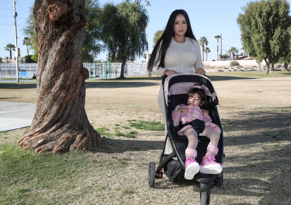 Maria Aylin Sotelo Comacho and her daughter Amelie walk through La Quinta Park.