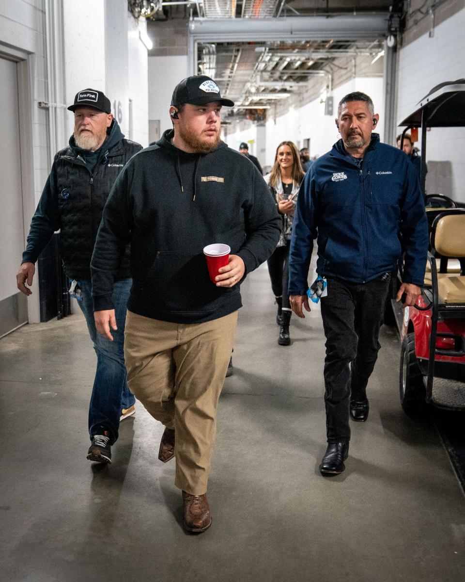 Luke Combs heads to the stage before performing at Empower Field at Mile High in Denver, Colo., Saturday, May 21, 2022. The show kicked off Combs’ first-ever headlining stadium tour.