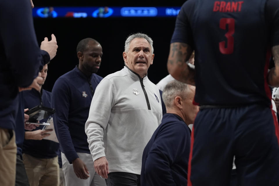 Duquesne head coach Keith Dambrot, center, speaks to his team during a timeout in the first half of an NCAA college basketball game against Dayton in the quarterfinals of the Atlantic 10 tournament Thursday, March 14, 2024, in New York. (AP Photo/Peter K. Afriyie)