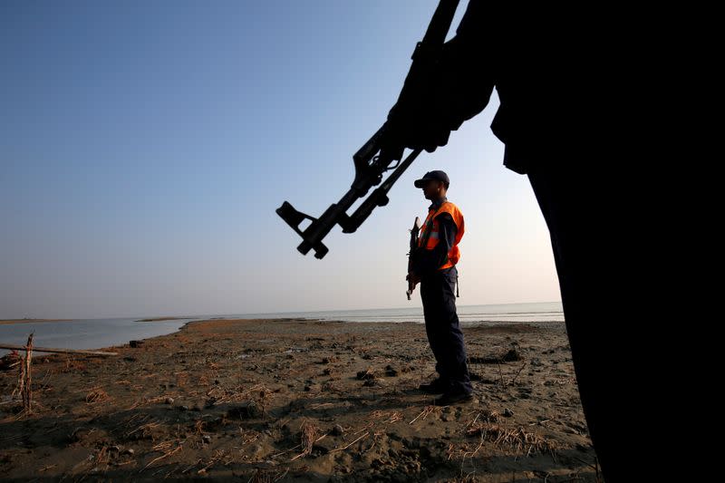 FILE PHOTO: Bangladesh coast guards keep watch in the Thengar Char island