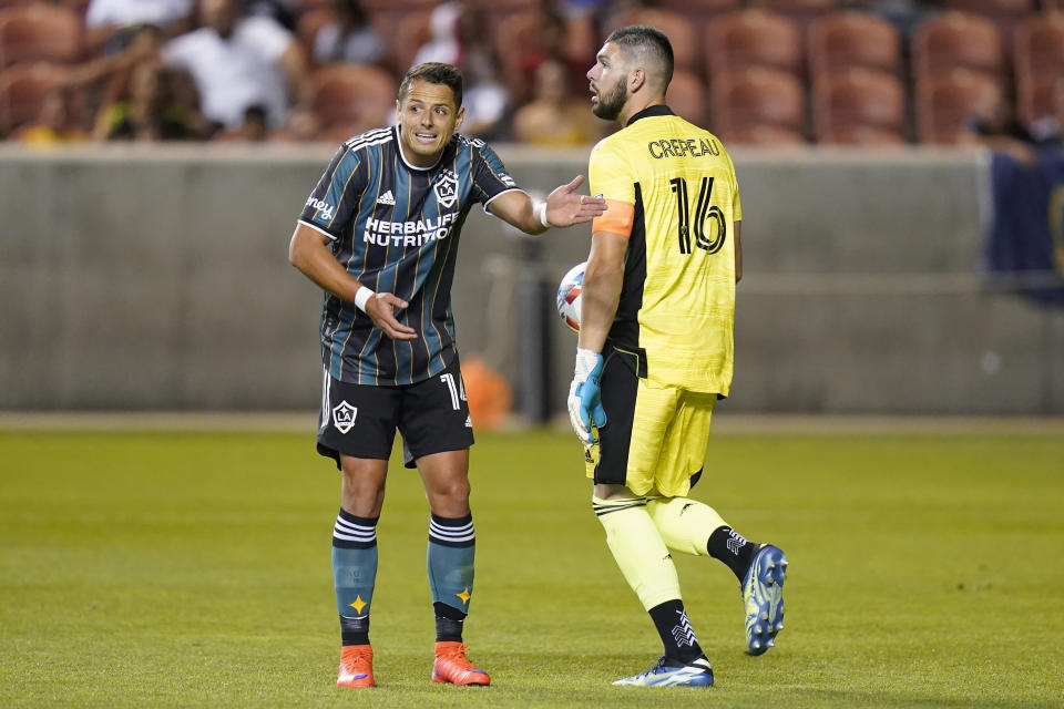 Los Angeles Galaxy's Chichartio, left, reacts after Vancouver Whitecaps goalkeeper Maxime Crepeau (16) makes a save in the second half during an MLS soccer match Wednesday, June 23, 2021, in Sandy, Utah. (AP Photo/Rick Bowmer)